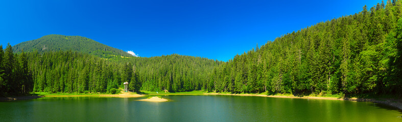 Carpathian mountains summer landscape with lake Sinevir and clear blue sky, natural background - panorama
