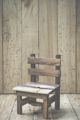 Obraz na płótnie Canvas mini wooden chair with wood wall