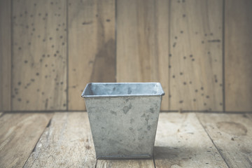 bucket of water on wood background, vintage filtered Images