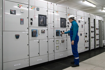 Man is in electrical energy distribution substation