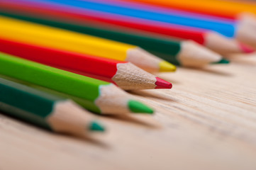 Group of bright colorful pencils on wooden table