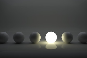 One illuminater ball among grey balls in the row concept.
