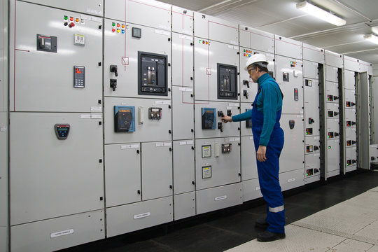 Man is in electrical energy distribution substation