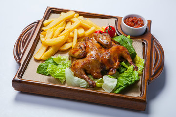 Chicken with potato and other vegetables on pan.