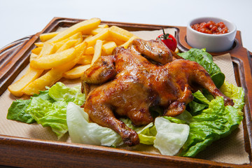 Chicken with potato and other vegetables on pan.