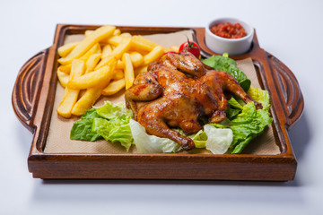 Chicken with potato and other vegetables on pan.