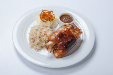 baked pork knuckle served with braised cabbage