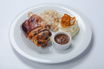 baked pork knuckle served with braised cabbage