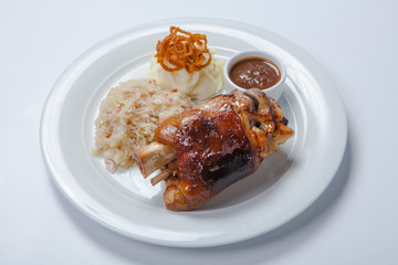 baked pork knuckle served with braised cabbage