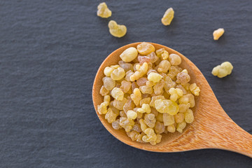 Wooden spoon of Aromatic yellow resin gum from Sudanese Frankincense tree, incense made by slashing...