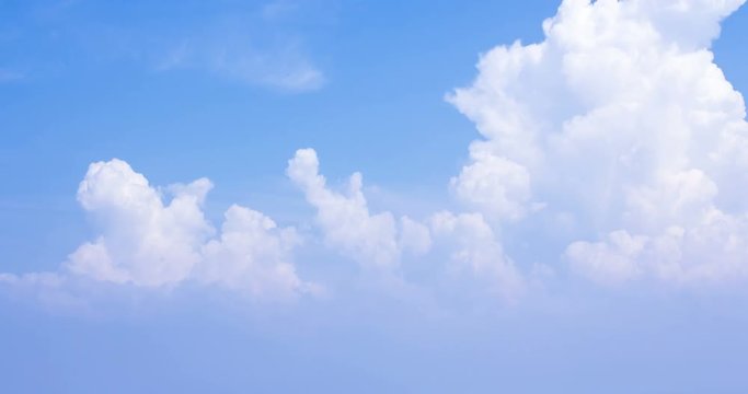 Beautiful cloudscape with large, building clouds and sunrise breaking through cloud mass.