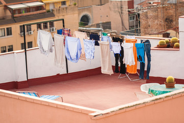 Fototapeta na wymiar Drying clothes in the open space in Tarragona (Spain). Roof Tarragona.