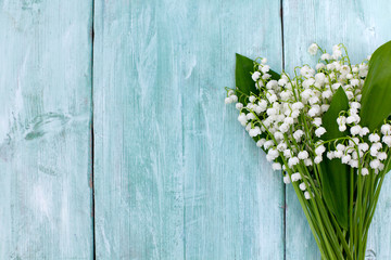 lilies of the valley on the wooden surface