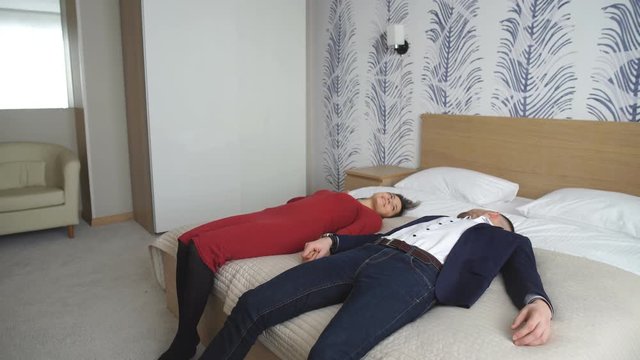 a happy young couple falls on the bed