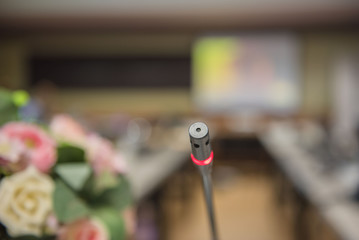 Close up microphone at conference in meeting room.