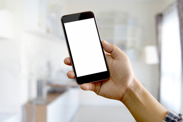 Man using Smartphone with blured office background.