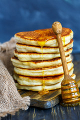 Stack of pancakes with honey.