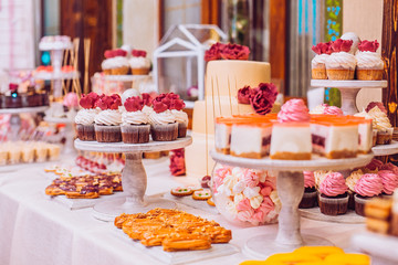 stylish luxury decorated orange candy bar for the celebration of a wedding of happy couple, cathering in the restaurant