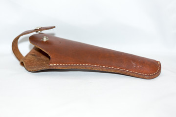 Holster of raw brown genuine leather for a pistol