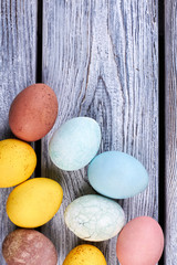 Group of colored eggs. Painted eggs on wooden background. General Easter food.