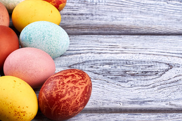 Colored eggs on wood. Easter eggs close up.