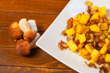 fried potatoes with mushrooms on plate