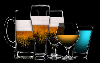 Set of multicolor different drinks in various glasses on black background
