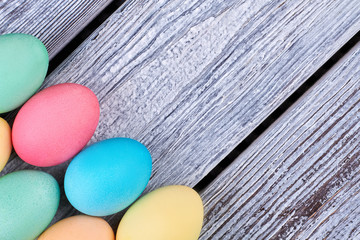 Bright Easter eggs on wood. Colored chicken eggs close up.