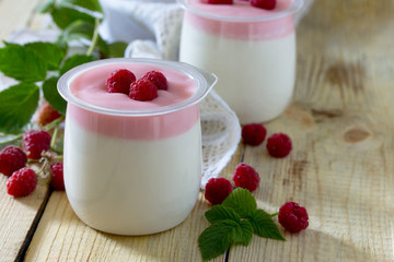 Homemade mousse with raspberries on a table in a rustic style.