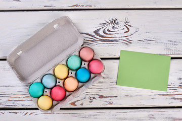 Easter egg tray, blank card. Green paper on white wood.