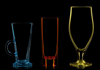 Silhouette of multicolor different glasses on black background