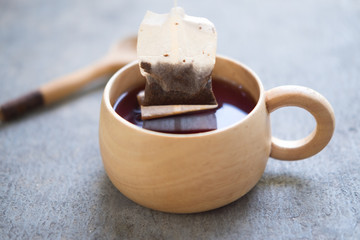 Tea bag in wooden cup