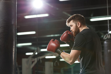 Handsome young strong sports man boxer make exercises