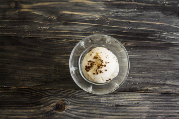Ice cream with coffee on a wooden table. Delicious dessert.