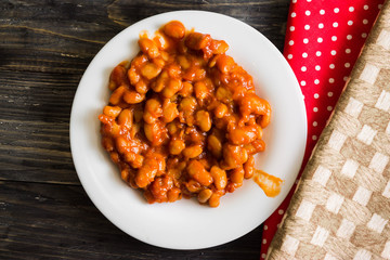 Beans in tomato in a white plate. A delicious dish.