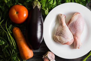 Chicken legs with fresh vegetables. Preparation for cooking.