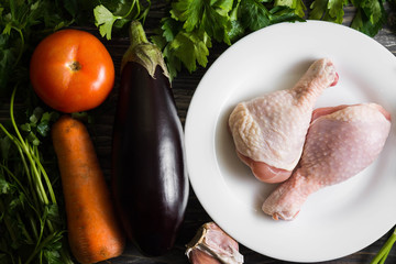 Chicken legs with fresh vegetables. Preparation for cooking.