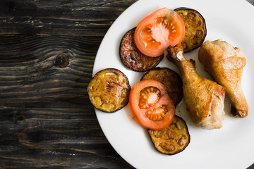 Fried chicken legs with vegetables. Tasty and nutritious dish.