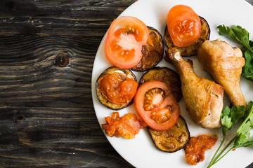 Fried chicken legs with vegetables. Tasty and nutritious dish.