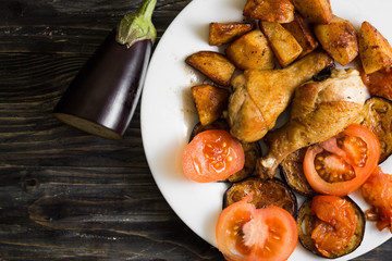 Fried chicken legs with vegetables. Tasty and nutritious dish.