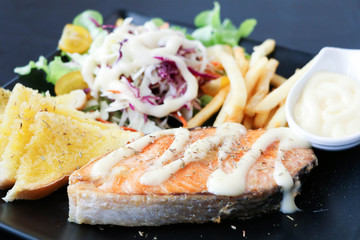 baked salmon steak with vegetables.