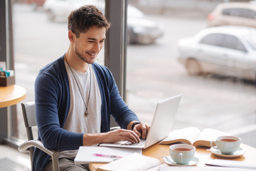 Young handsome guy working on computer