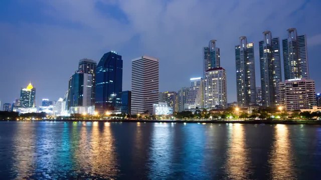 time lapse of city downtown at night with reflection of skyline in Bangkok,Thailand