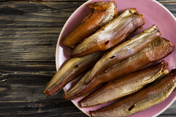 Smoked fish on a wooden table in rustic style