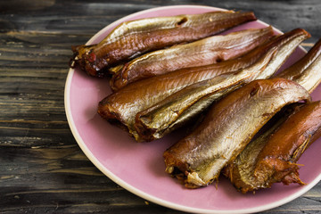Smoked fish on a wooden table in rustic style