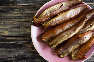 Smoked fish on a wooden table in rustic style