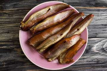 Smoked fish on a wooden table in rustic style