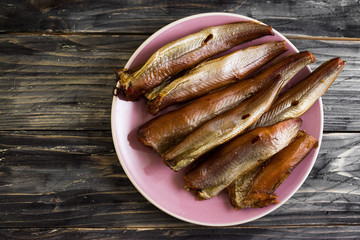 Smoked fish on a wooden table in rustic style