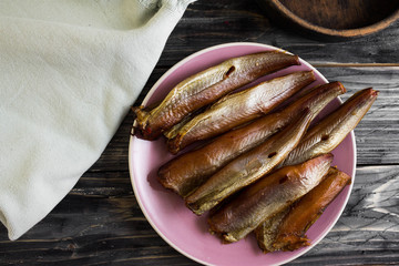 Smoked fish on a wooden table in rustic style