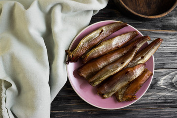 Smoked fish on a wooden table in rustic style